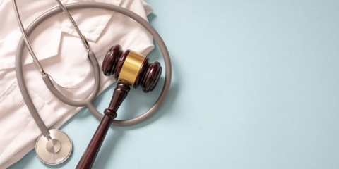 doctor coat, stethoscope and judges gavel