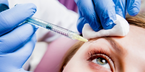 woman receiving eyebrow injection
