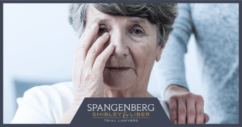 elderly woman holding her face in a nursing home