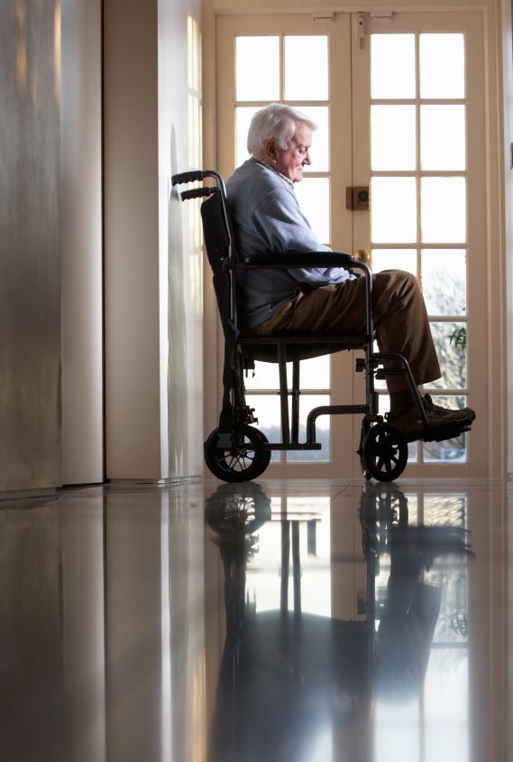 elderly patient in wheelchair looking melancholy