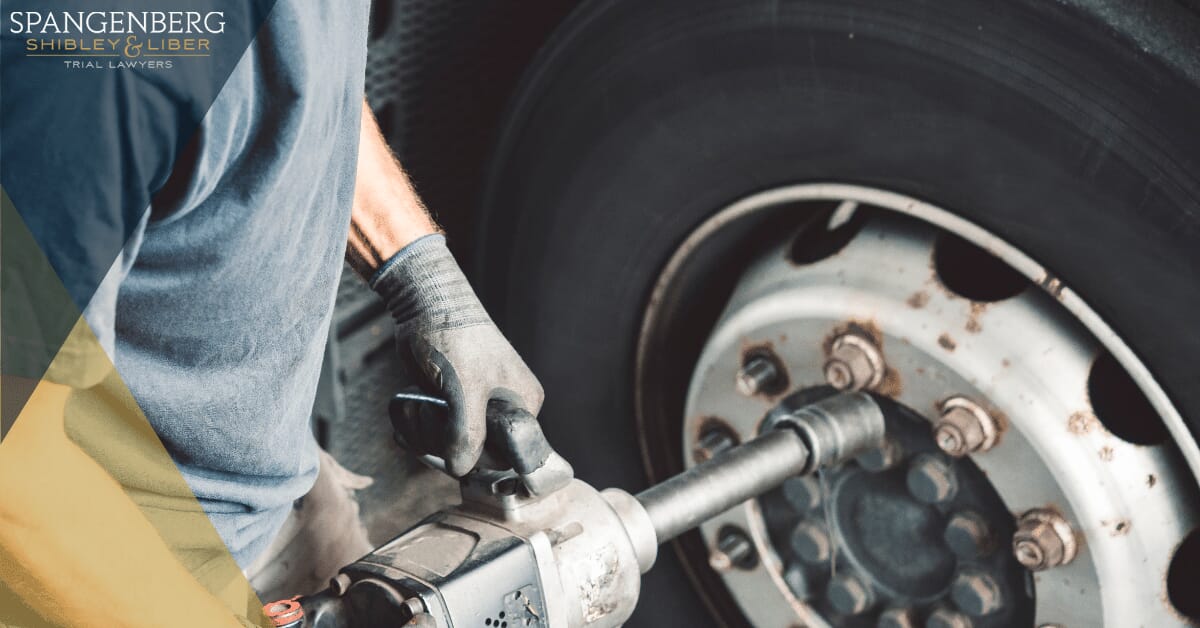 someone working on a commercial truck tire