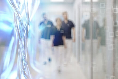 Blurred Photo of Three Doctors Walking Down the Hallway